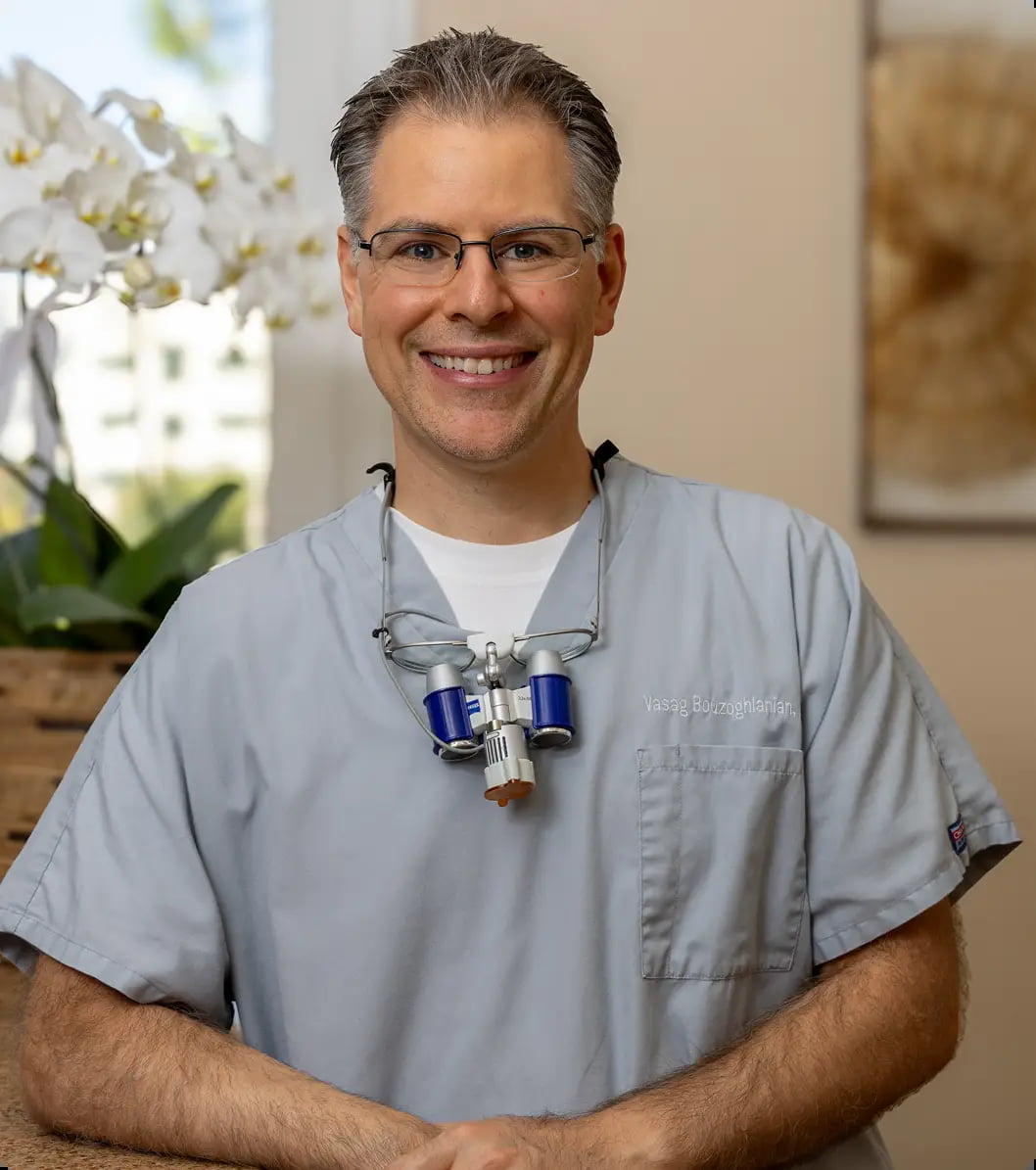 Portrait of Dr. Vasag Bouzoghlanian smiling in a suit